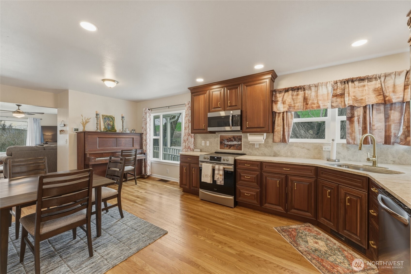 315 Thorn Hollow Road Dayton, WA 99328 - Photo 9 of 40 a kitchen with stainless steel appliances granite countertop a stove top oven a sink dishwasher a dining table and chairs with wooden floor