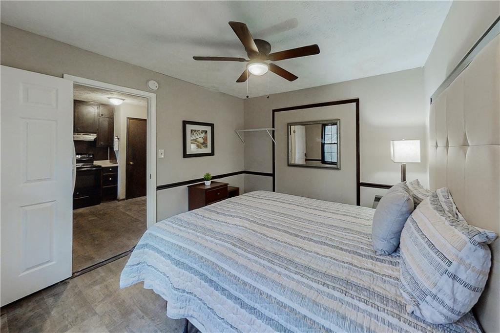 2284 Emerald Springs Drive Decatur, GA 30035 - Photo 12 of 30 a bedroom with a large bed and a chandelier