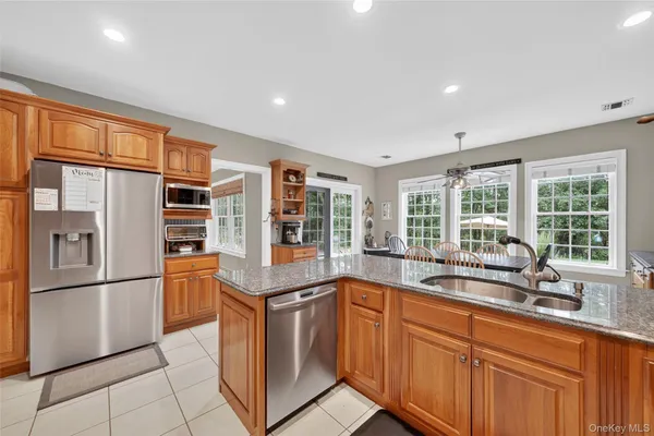 a kitchen with stainless steel appliances granite countertop a refrigerator and a sink