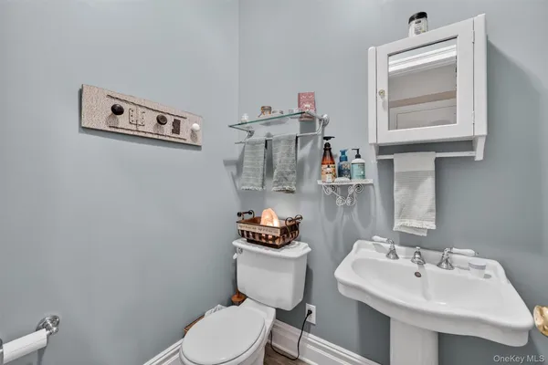 a bathroom with a sink mirror and toilet