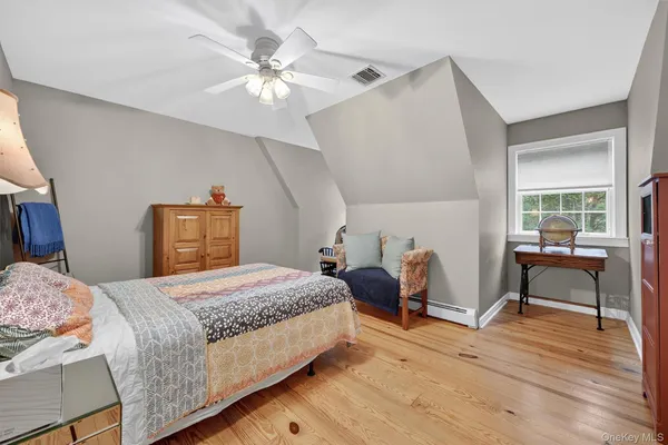 a bedroom with a bed and a table chair