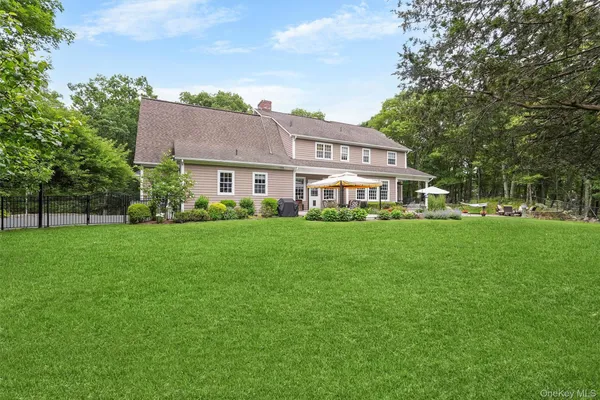a front view of house with yard and green space