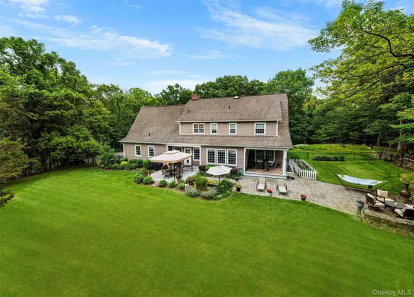 an aerial view of a house with backyard garden and outdoor seating