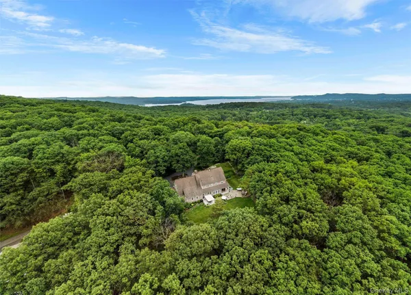 an aerial view of a house with a yard