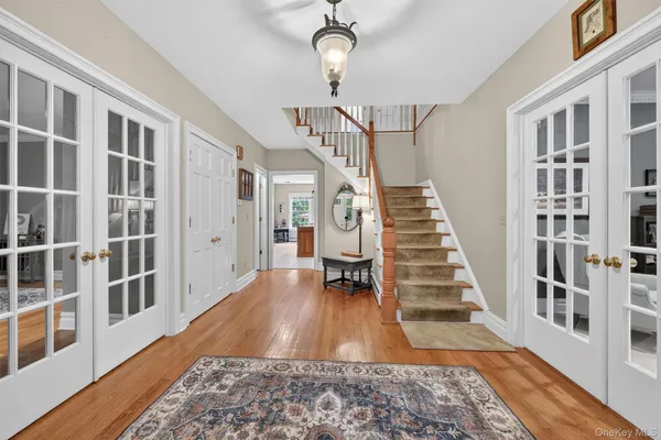 a view of staircase with lots of frames and paintings on the wall