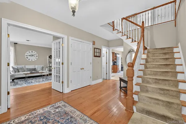 a view of entryway and hall with wooden floor