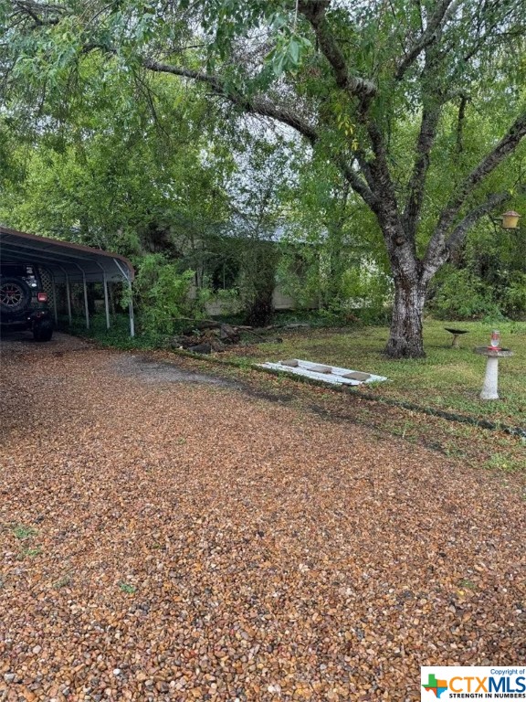 5341 Highway 35 Port Lavaca, TX 77979 - Photo 2 of 3 a backyard of a house with trees and wooden fence