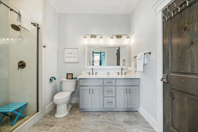 a spacious bathroom with a granite countertop sink toilet a large mirror a shower and a bathtub
