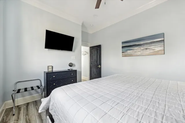 a bed room with a bed a television and a dresser