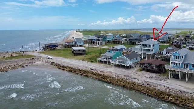 an aerial view of a house with garden space and street view