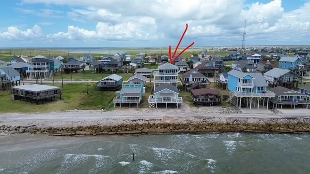 an aerial view of a house with a lake view