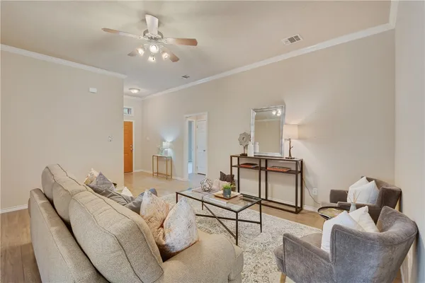 a living room with furniture and a chandelier
