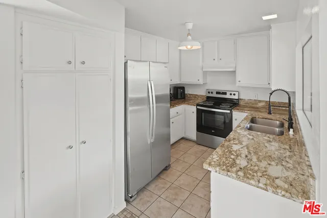 a view of a kitchen with a sink and a window