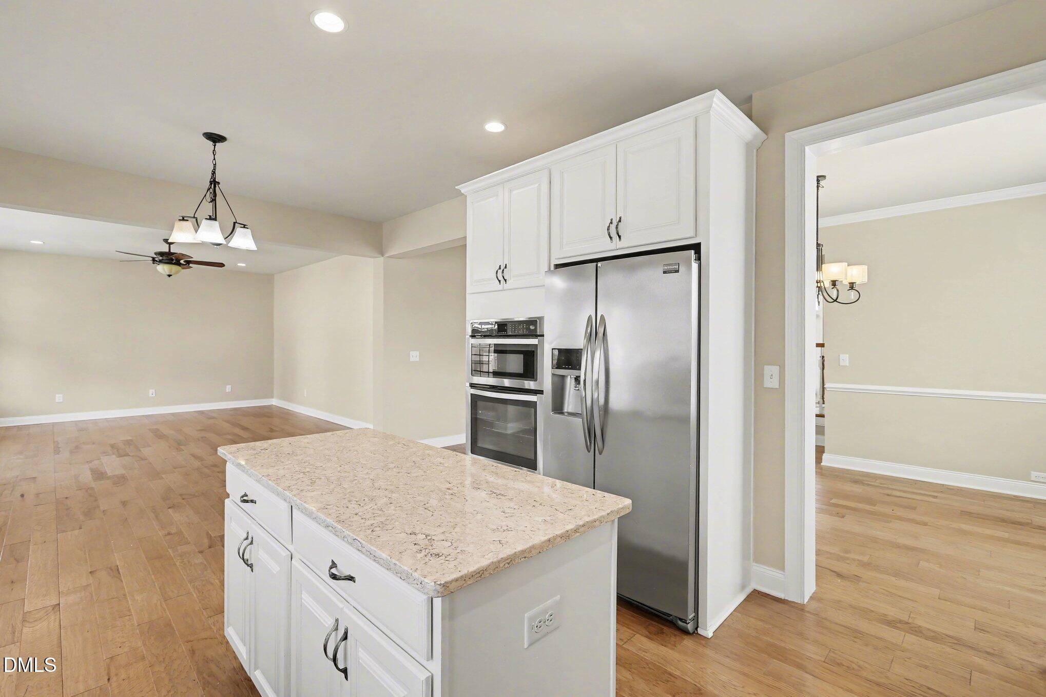 351 Gartrell Way Cary, NC 27519 - Photo 19 of 51 a kitchen with kitchen island a counter top space appliances and cabinets