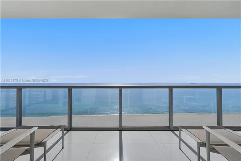 a view of balcony with floor to ceiling windows