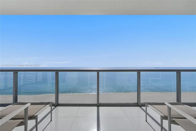 a view of balcony with floor to ceiling windows