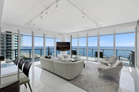 a living room with fireplace furniture and a large window