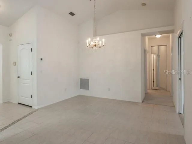 a view of a chandelier in big room and chandelier
