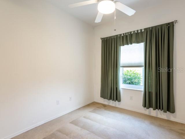 6 Summer Terrace, Unit 6 Palm Coast, FL 32137 - Photo 23 of 30 an empty room with a window and a fan