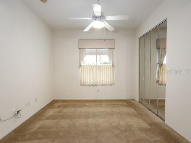 6 Summer Terrace, Unit 6 Palm Coast, FL 32137 - Photo 24 of 30 an empty room with a window and a fan