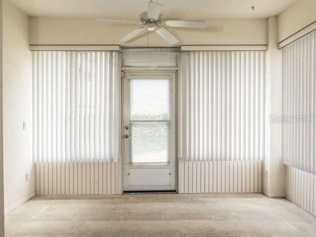6 Summer Terrace, Unit 6 Palm Coast, FL 32137 - Photo 26 of 30 an empty room with wooden floor and windows