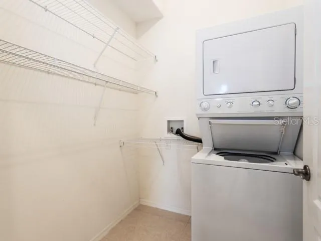 a view of storage and utility room with closet