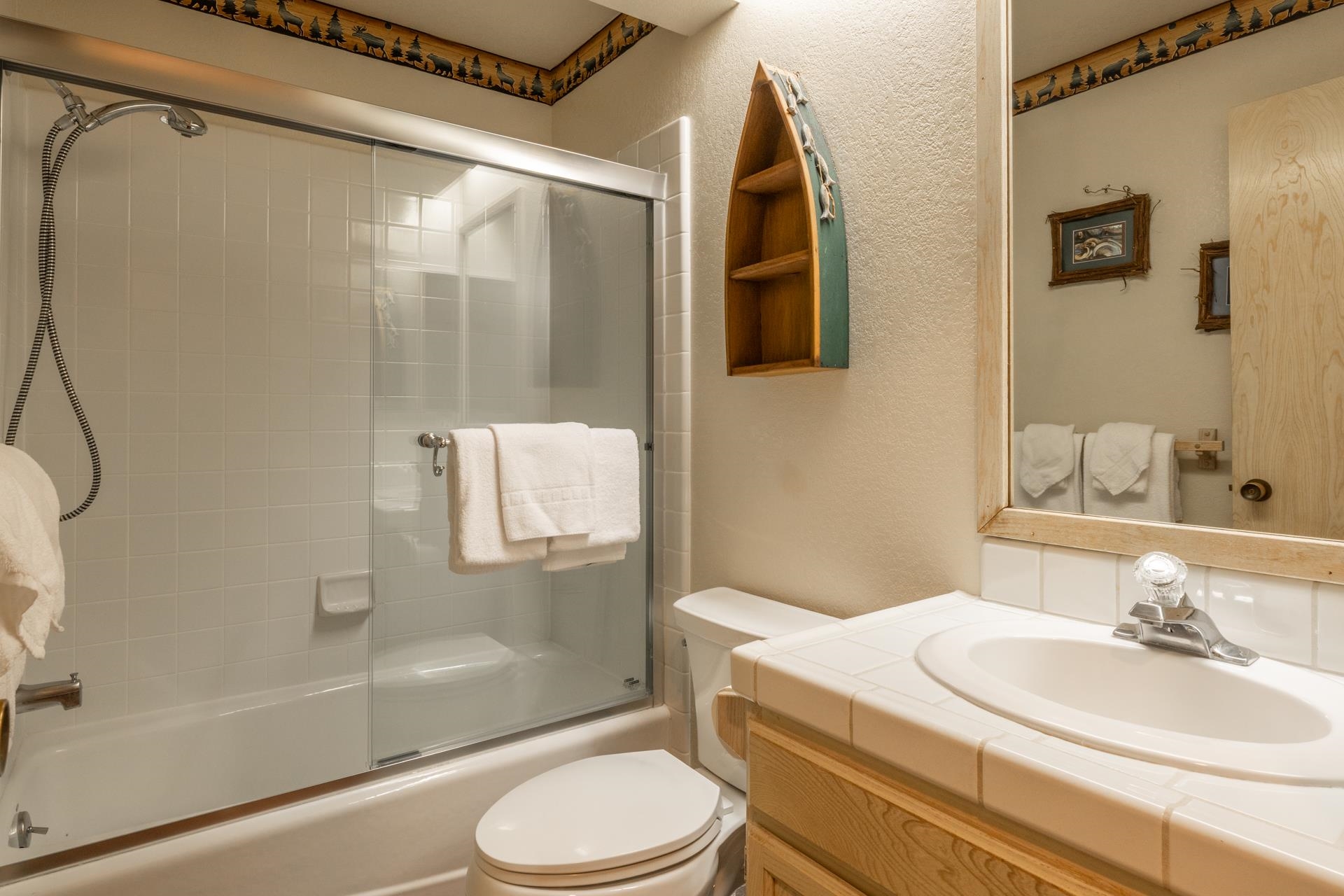 613 Golden Creek Road, Unit 613 Mammoth Lakes, CA 93546 - Photo 18 of 24 Bathroom featuring bath / shower combo with glass door, vanity, and a textured wall