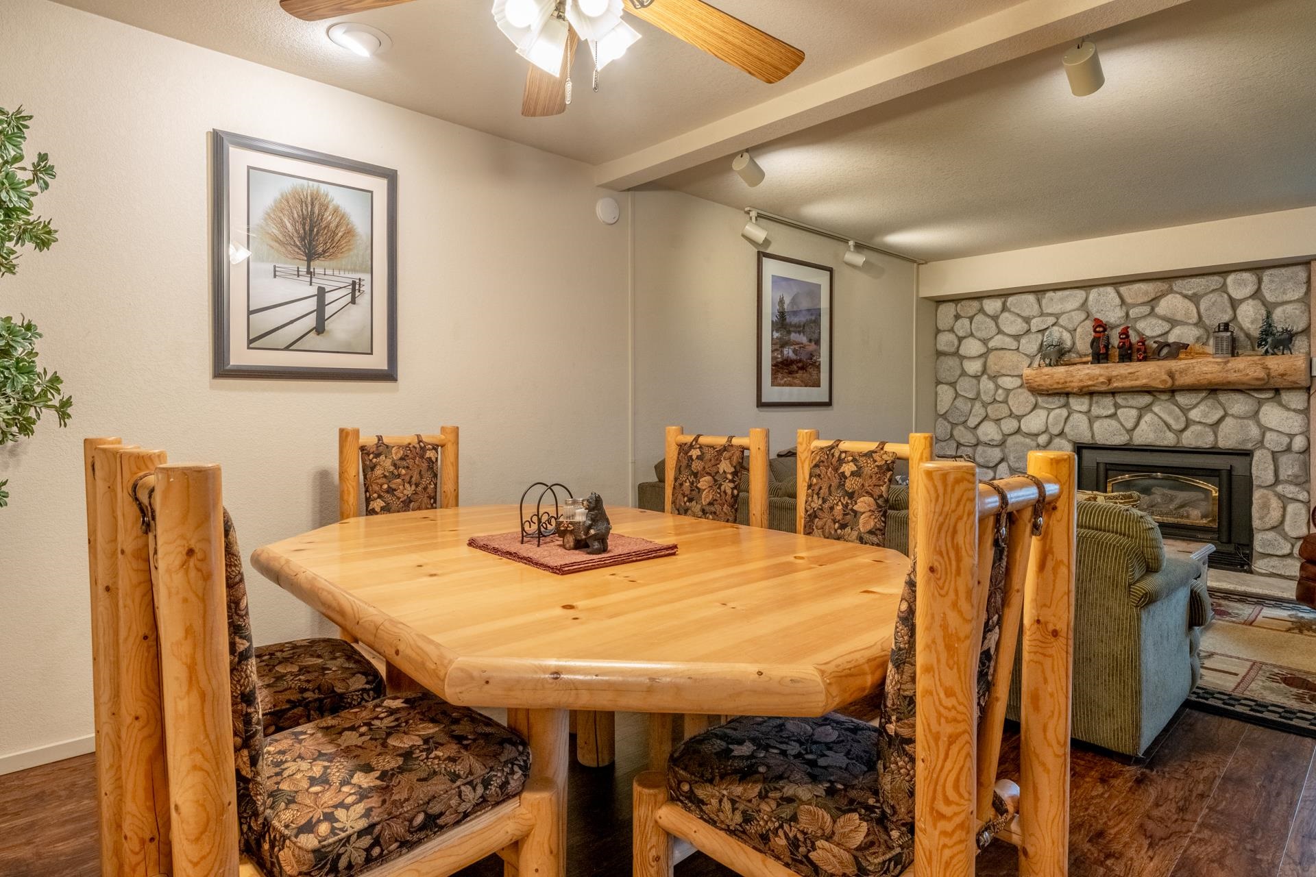 613 Golden Creek Road, Unit 613 Mammoth Lakes, CA 93546 - Photo 3 of 24 Dining room with dark wood-style flooring, rail lighting, ceiling fan, a textured ceiling, and a fireplace