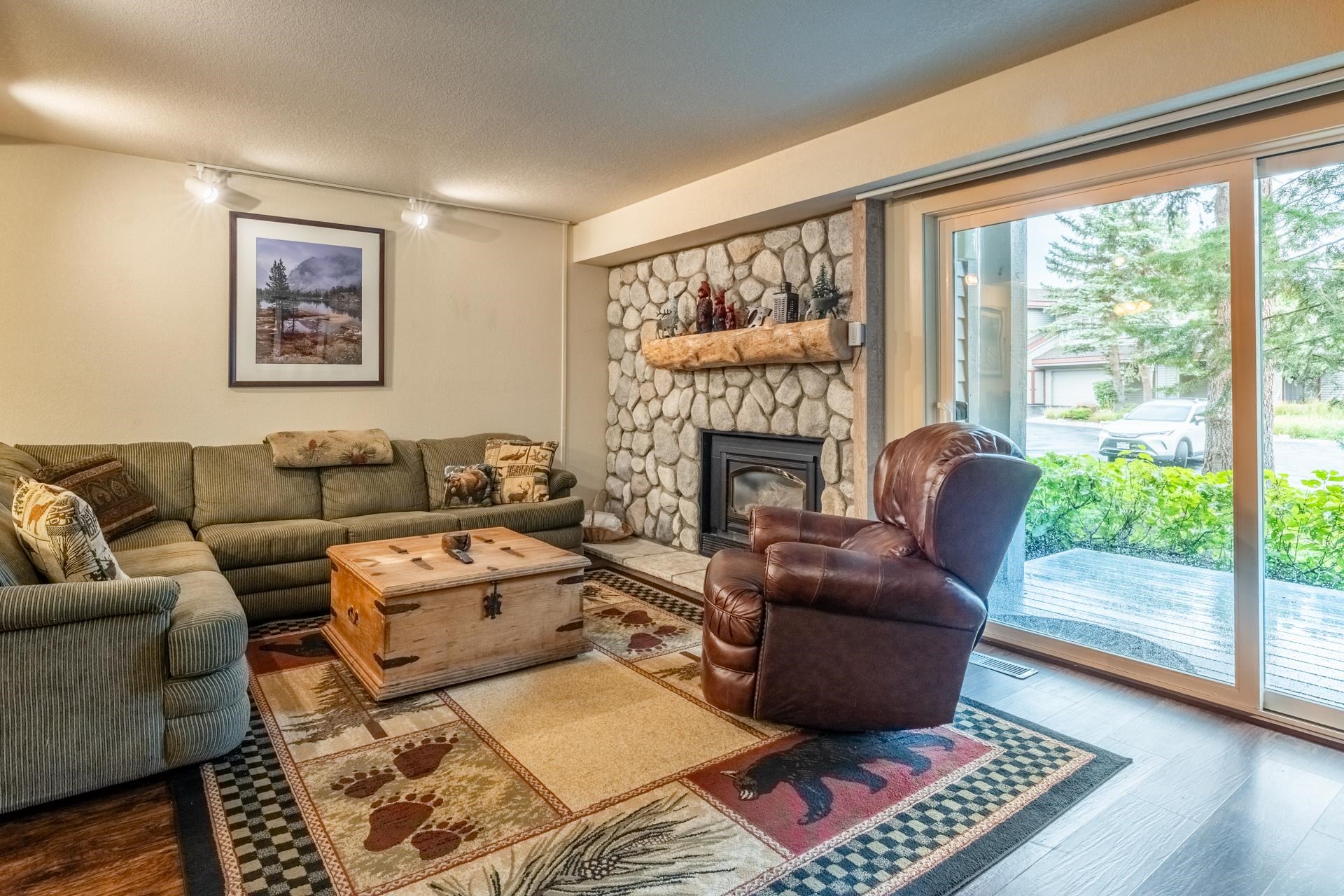 613 Golden Creek Road, Unit 613 Mammoth Lakes, CA 93546 - Photo 5 of 24 Living room with wood finished floors, a fireplace, and a textured ceiling