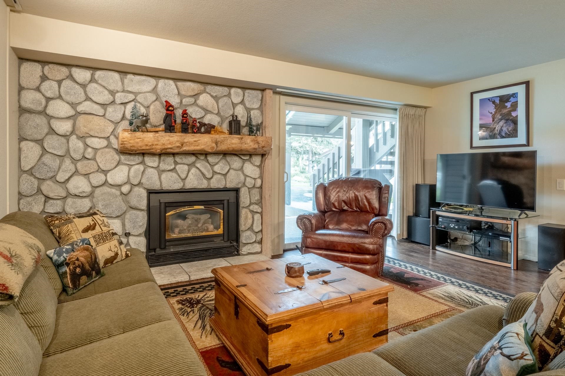613 Golden Creek Road, Unit 613 Mammoth Lakes, CA 93546 - Photo 6 of 24 Living area featuring a stone fireplace and wood finished floors