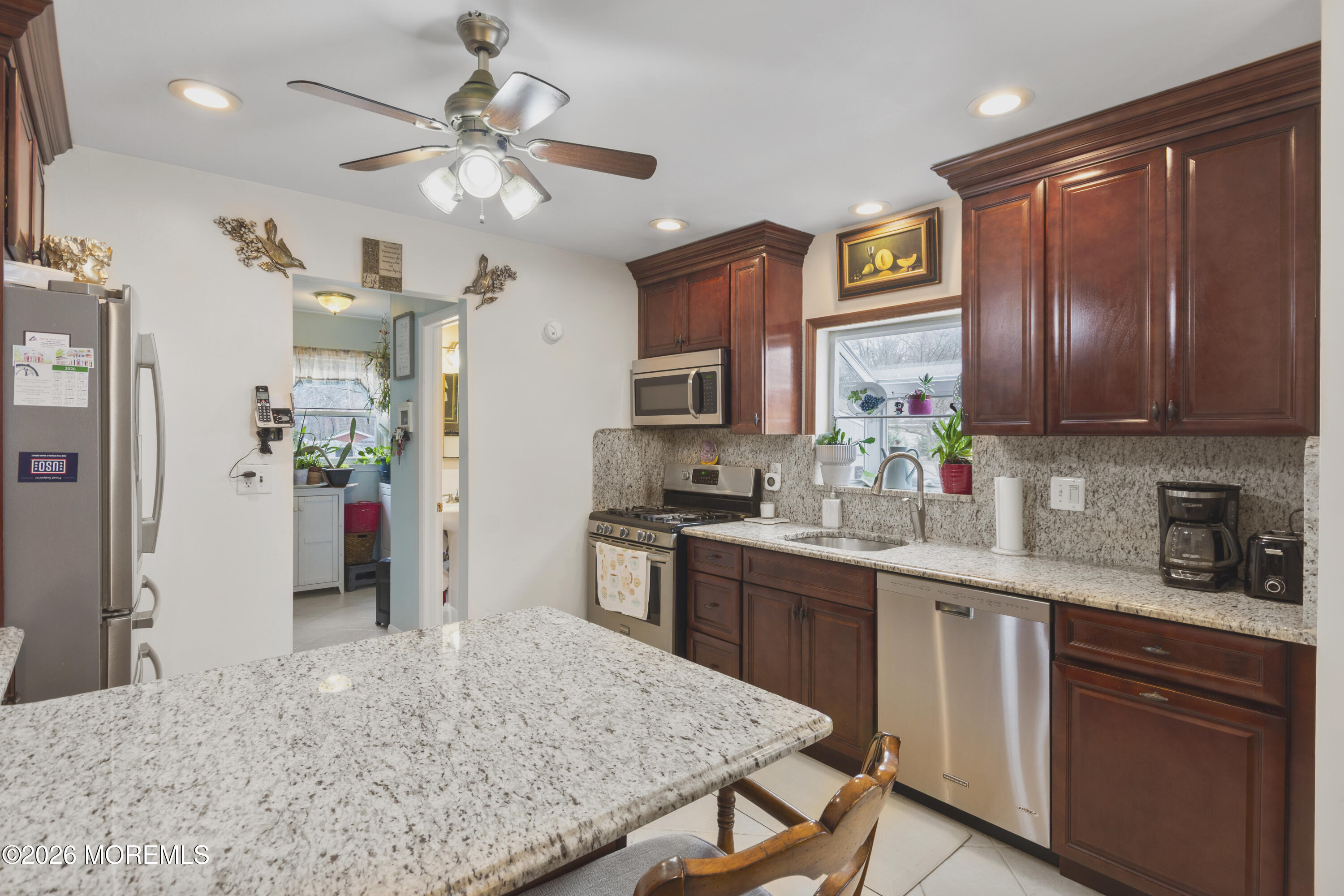 416 Midstreams Road Brick, NJ 08724 - Photo 12 of 27 a kitchen with stainless steel appliances granite countertop wooden cabinets a refrigerator a sink a stove and island