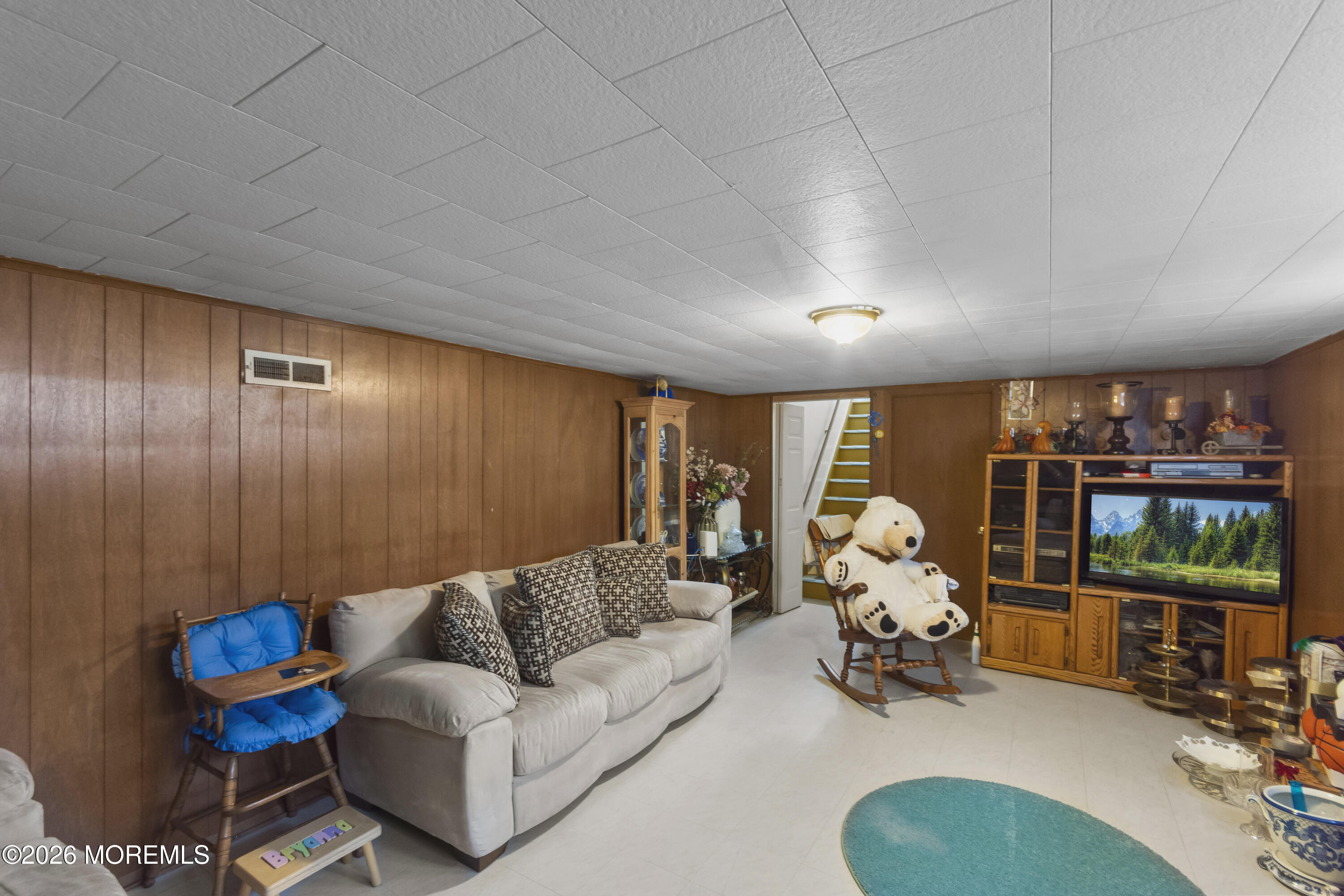 416 Midstreams Road Brick, NJ 08724 - Photo 23 of 27 a living room with furniture a flat screen tv and a large window