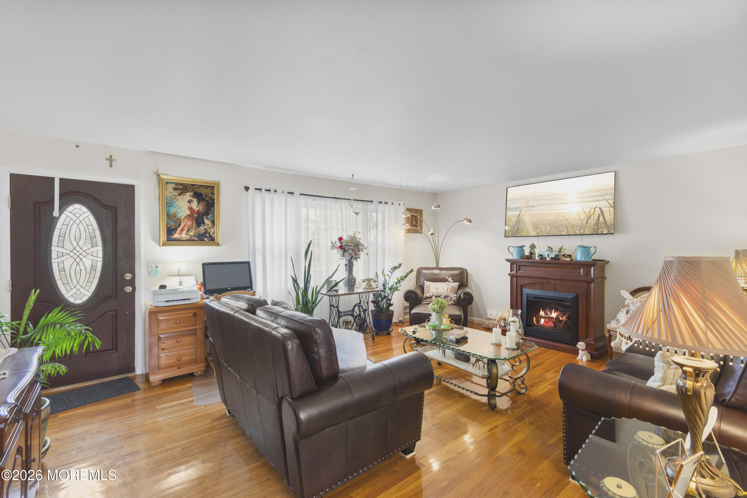 416 Midstreams Road Brick, NJ 08724 - Photo 4 of 27 a living room with furniture a fireplace and a potted plant