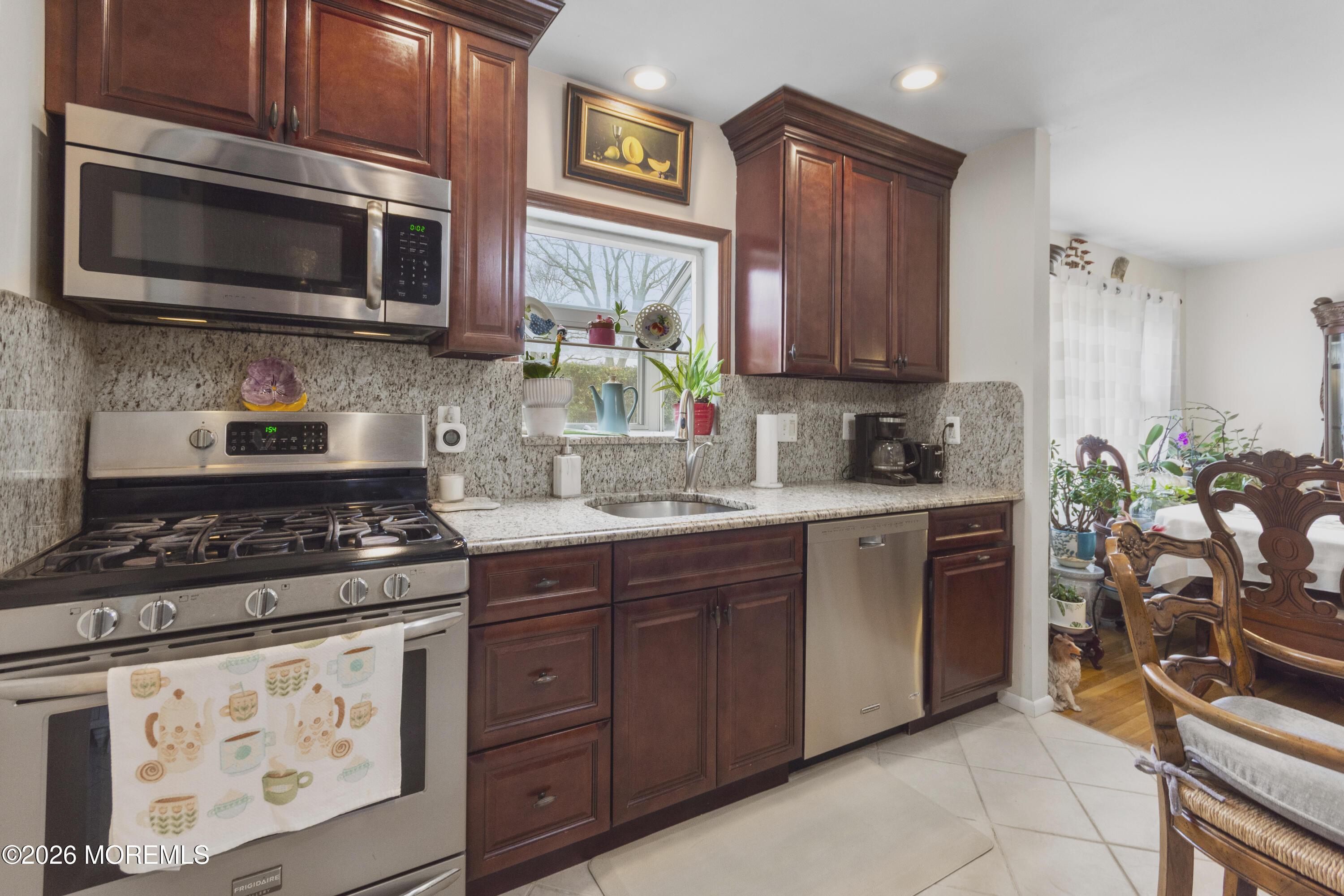 416 Midstreams Road Brick, NJ 08724 - Photo 10 of 27 a kitchen with stainless steel appliances granite countertop a stove a sink and a microwave