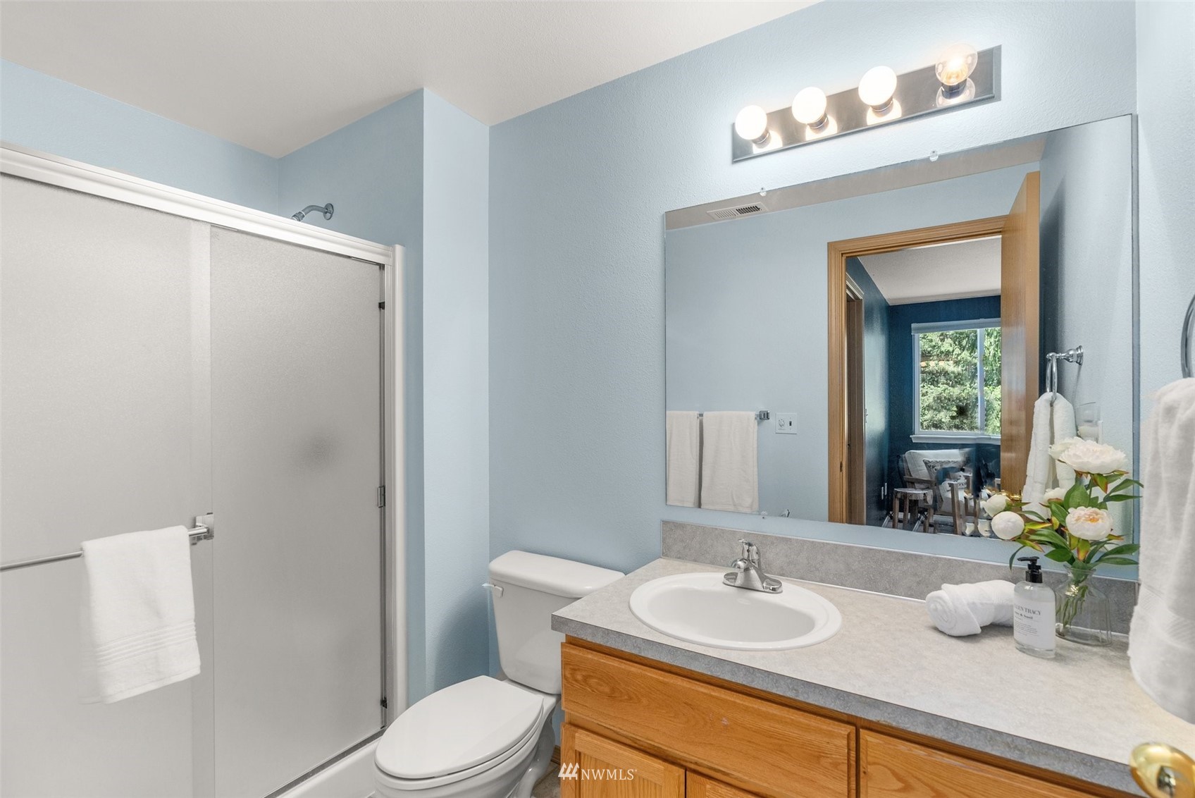 320 Tennessee Road Winlock, WA 98596 - Photo 17 of 40 a bathroom with a granite countertop sink and a mirror with toilet