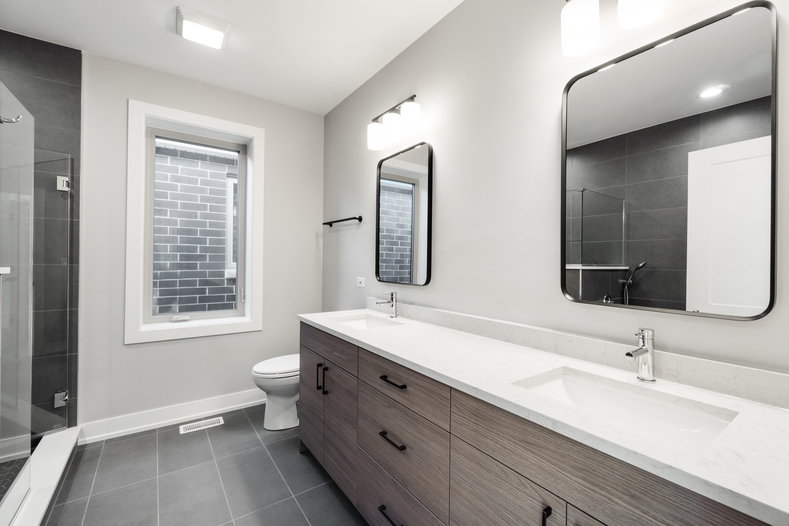 4167 South Halsted Street Chicago, IL 60609 - Photo 11 of 25 a bathroom with a double vanity sink a mirror and a