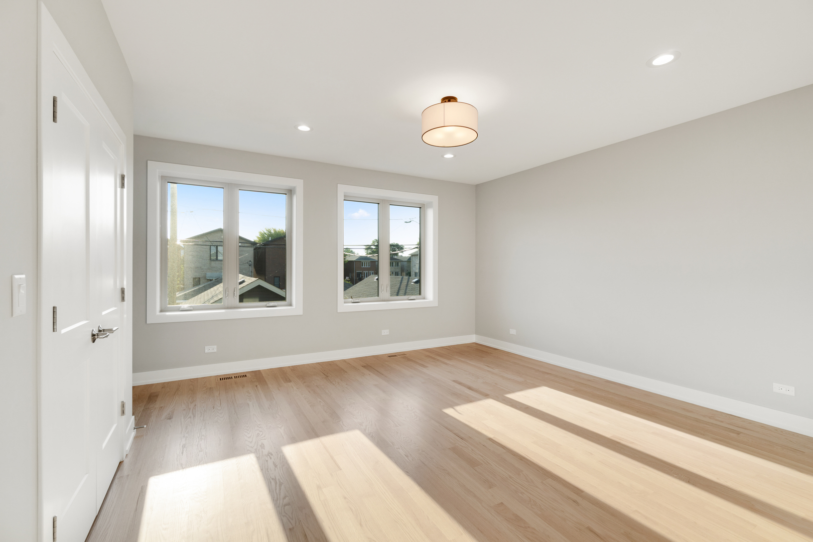 4167 South Halsted Street Chicago, IL 60609 - Photo 12 of 25 an empty room with wooden floor and windows