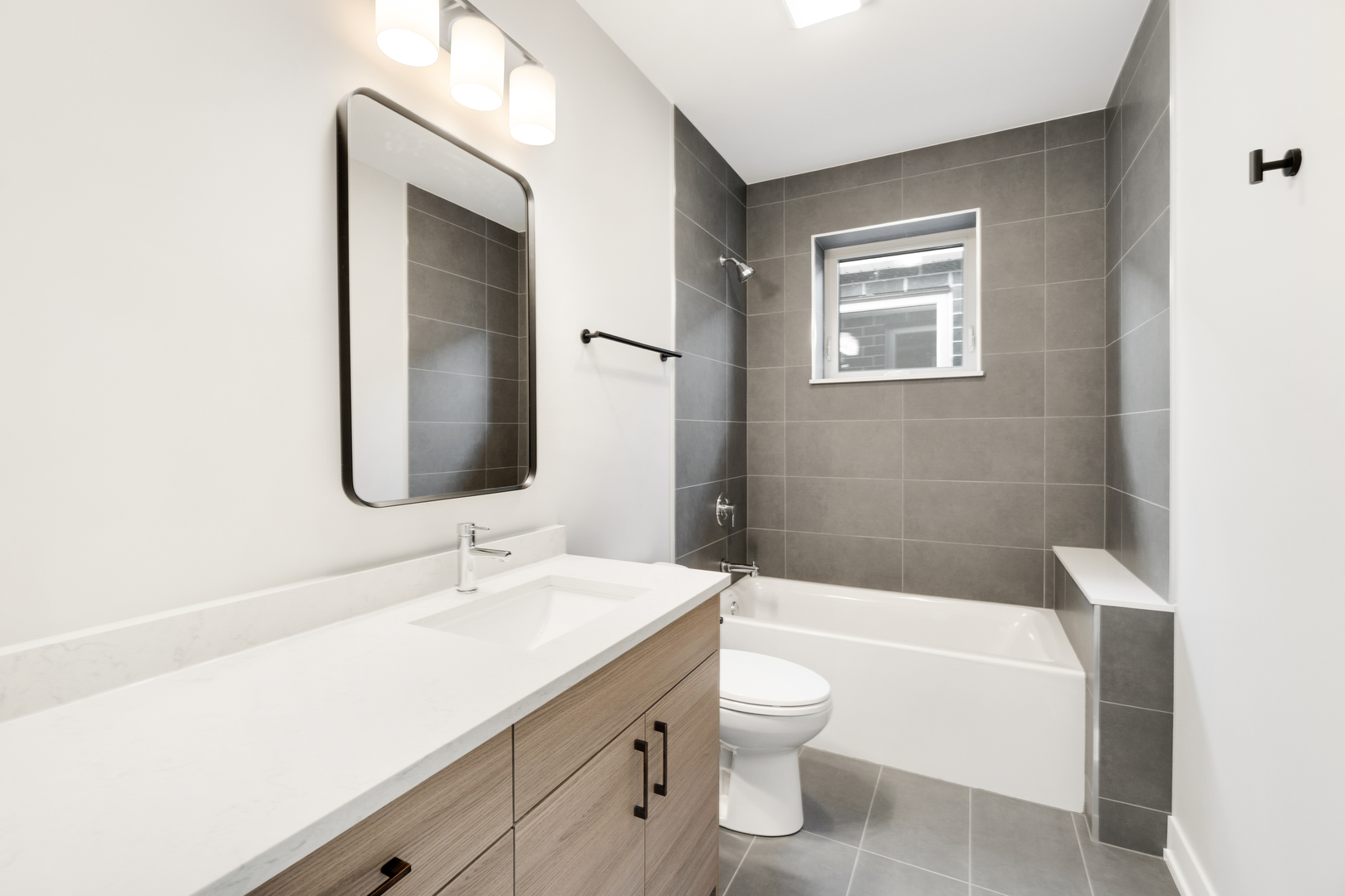 4167 South Halsted Street Chicago, IL 60609 - Photo 17 of 25 a bathroom with a toilet a sink a mirror and a bathtub