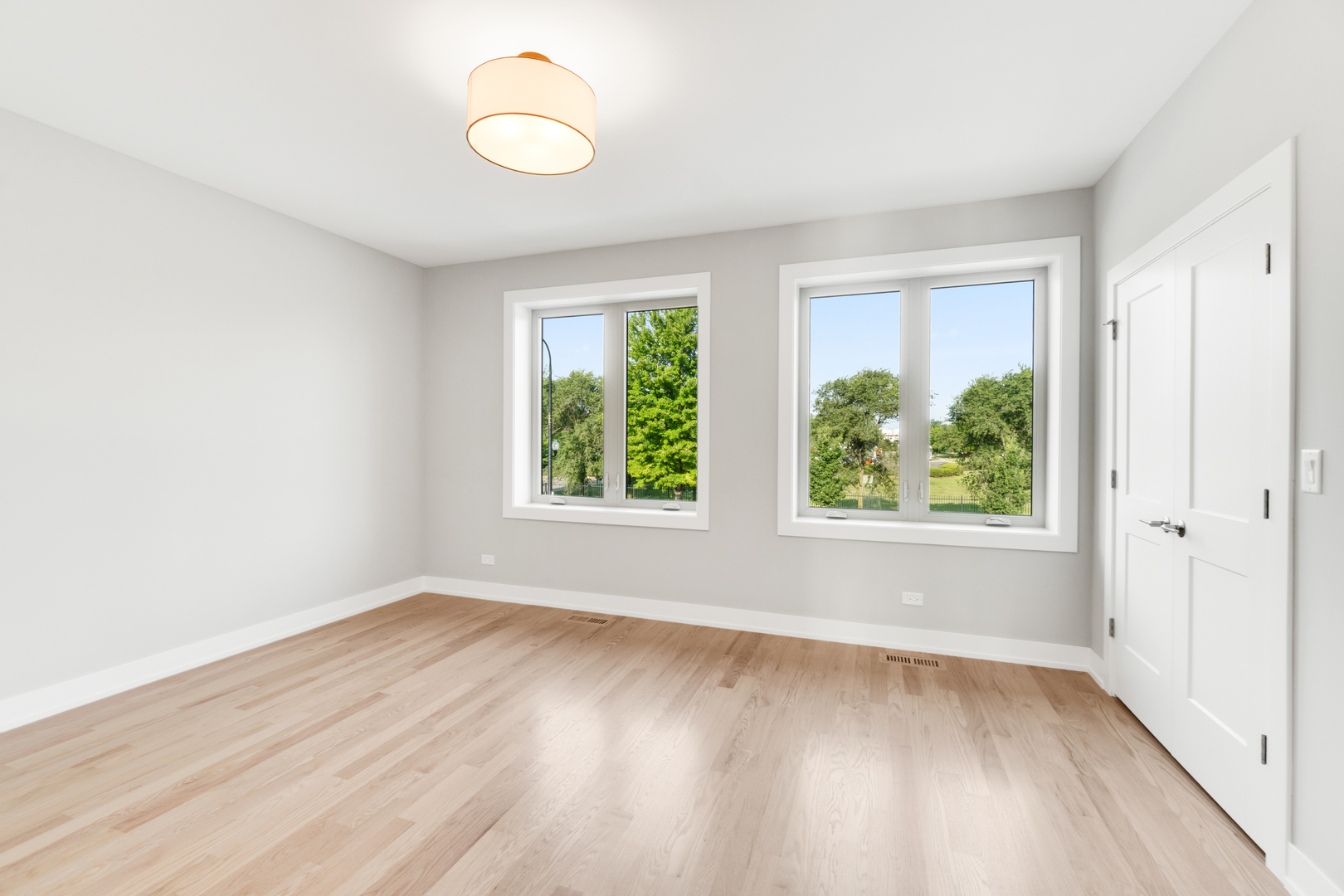 4167 South Halsted Street Chicago, IL 60609 - Photo 19 of 25 an empty room with wooden floor and windows