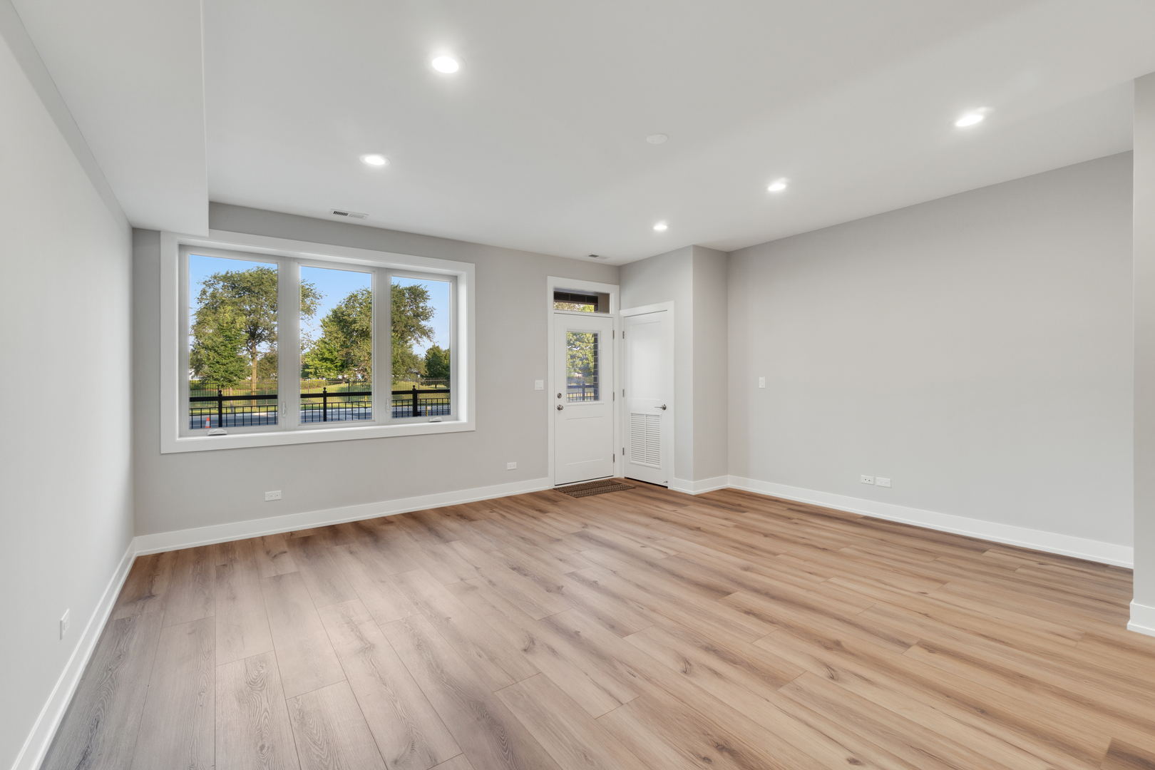 4167 South Halsted Street Chicago, IL 60609 - Photo 3 of 25 an empty room with wooden floor and windows