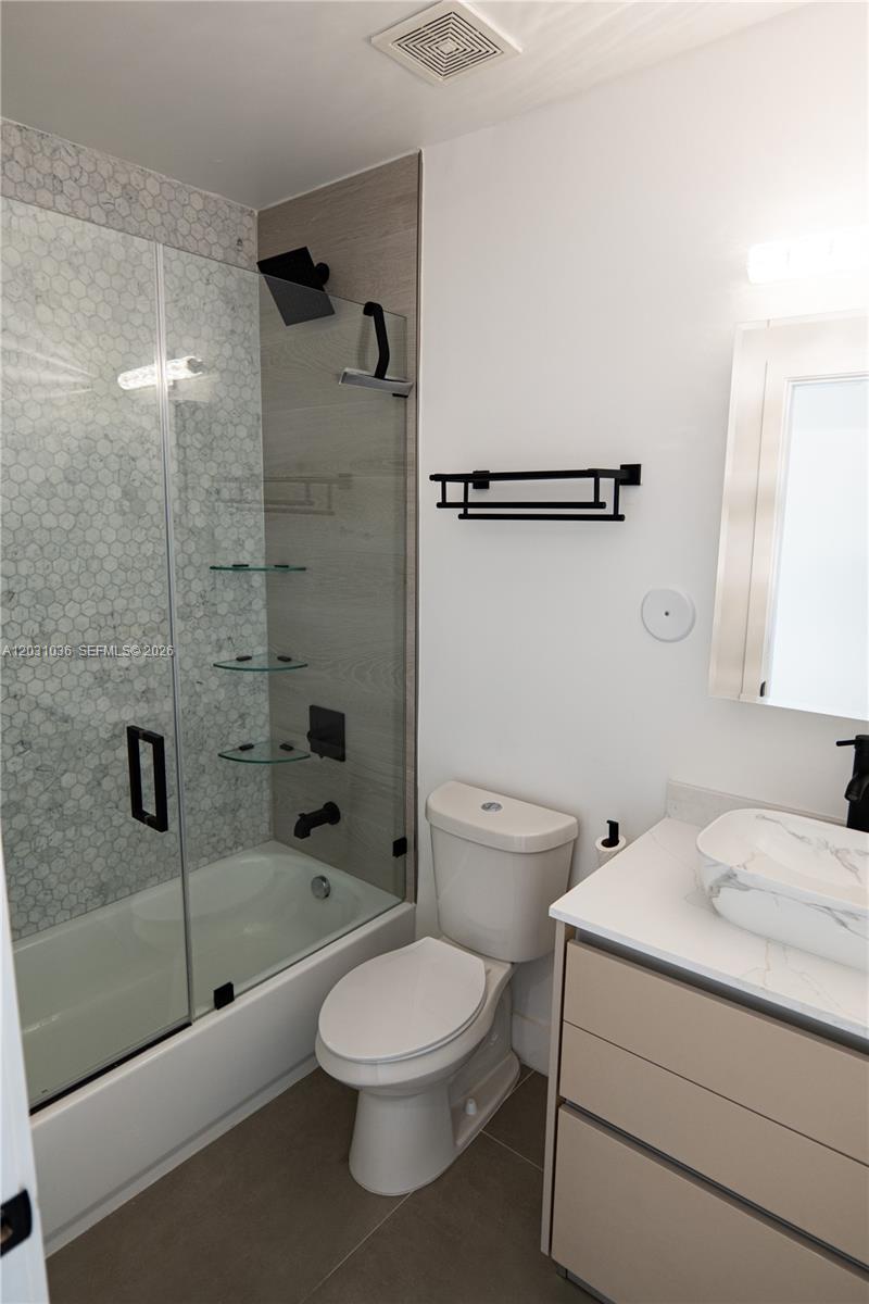 1721 Southwest 13th Street, Unit 4 Miami, FL 33145 - Photo 17 of 24 a bathroom with a toilet sink and shower
