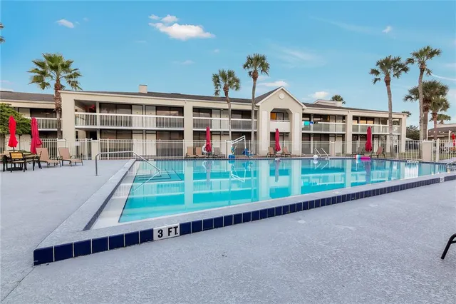 a front view of a house with a yard and potted plants