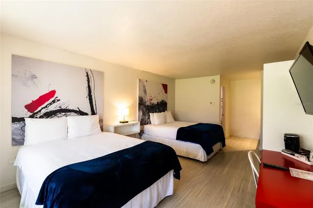 a bedroom with a bed and a potted plant