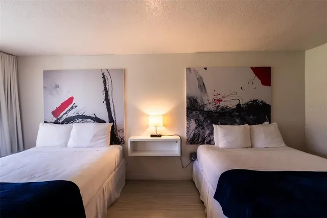 a bedroom with a bed and a painting on the wall