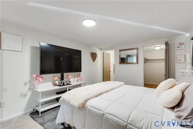 a view of an empty room with closet and wooden floor