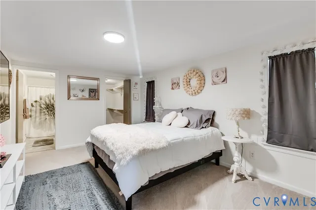 a bedroom with a bed and a table with mirror