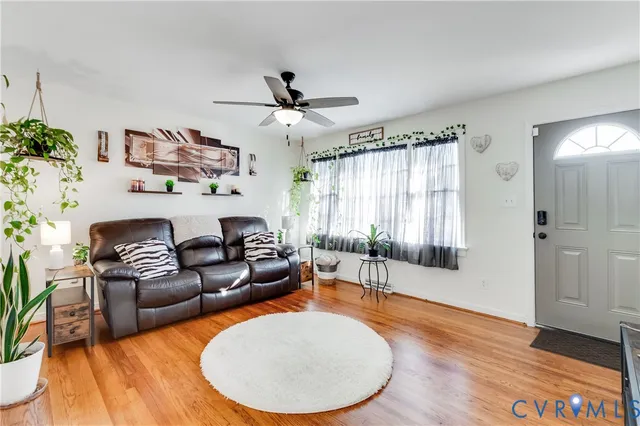 a living room with furniture and a wooden floor