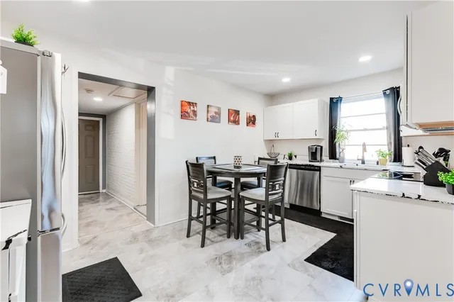 a kitchen with a table and chairs