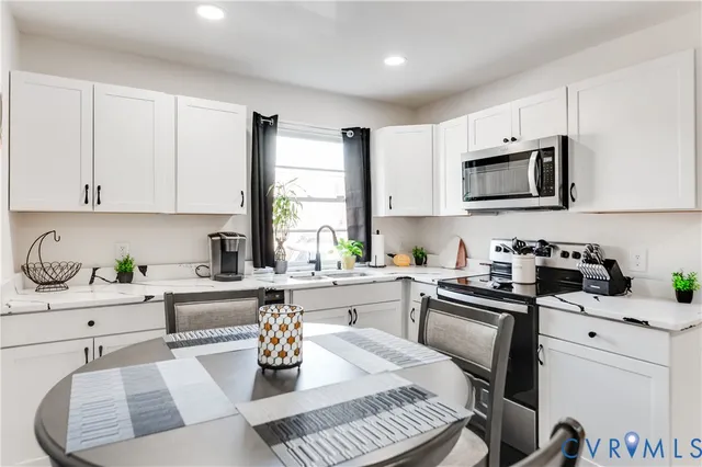 a bedroom with a bed and a large mirror on the dresser