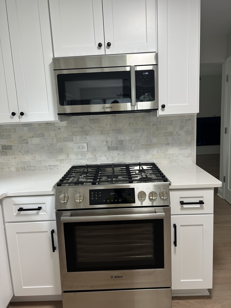 1106 Waukegan Road Deerfield, IL 60015 - Photo 11 of 29 a stove top oven sitting inside of a kitchen